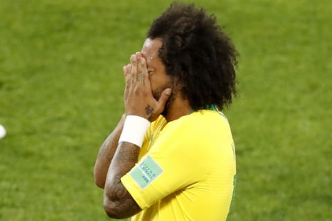Brazil's Marcelo covers his face during the group E match between Serbia and Brazil, at the 2018 soccer World Cup in the Spartak Stadium in Moscow, Russia, Wednesday, June 27, 2018. (AP Photo/Antonio Calanni)