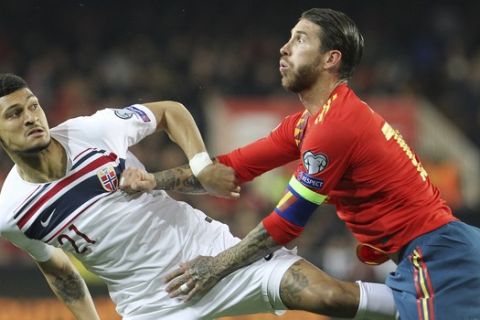 Spain's Sergio Ramos, right, challenges for the ball with Norway's Bjorn Johnsen during the Euro 2020 group F qualifying soccer match between Spain and Norway at the Mestalla stadium in Valencia, Spain, Saturday, March 23, 2019. (AP Photo/Alberto Saiz)