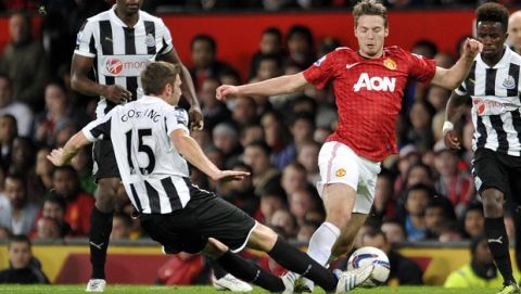 Manchester United's Nick Powell, right is tackled by Newcastle's United's Dan Gosling, left during their English League Cup third round match at Old Trafford in Manchester, England, Wednesday Sept. 26, 2012. (AP Photo/Clint Hughes)  
