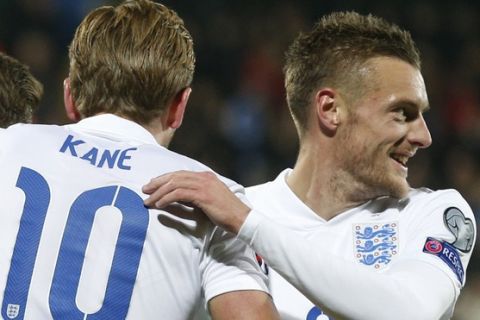 England's Adam Lallana, Harry Kane, center, and Jamie Vardy, left, celebrates after scoring goal during the Euro 2016 group E qualifying soccer match between the Lithuania and England at the LFF stadium in Vilnius, Lithuania, Monday, Oct. 12, 2015. (AP Photo/Mindaugas Kulbis)