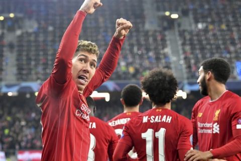 Liverpool's Roberto Firmino, left, celebrates after Liverpool's Mohamed Salah scored his side's second goal during the group E Champions League soccer match between Salzburg and Liverpool, in Salzburg, Austria, Tuesday, Dec. 10, 2019. (AP Photo/Kerstin Joensson)