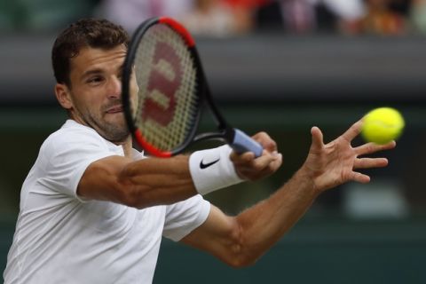 Bulgaria's Grigor Dimitrov returns to Switzerland's Roger Federer during their Men's Singles Match on day seven at the Wimbledon Tennis Championships in London Monday, July 10, 2017. (AP Photo/Kirsty Wigglesworth)