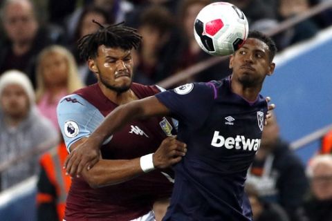 Aston Villa's Tyrone Mings, left, duels for the ball with West Ham's Sebastien Haller during their English Premier League soccer match between Aston Villa and West Ham United at Villa Park in Birmingham, England, Monday, Sept. 16, 2019. (AP Photo/Rui Vieira)