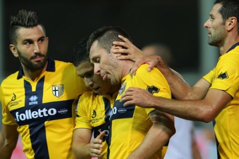Parma's Antonio Cassano celebrates with teammates after scoring during the Serie A soccer match between Udinese and Parma at the Friuli Stadium in Udine, Italy, Monday Sept. 29, 2014. (AP Photo/Paolo Giovannini)