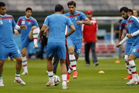 Iran's Karim Ansarifard, rear center, challenges for the ball with teammates during an official training session the day before the group F World Cup soccer match between Iran and Nigeria at the Arena da Baixada in Curitiba, Brazil, Sunday, June 15, 2014.  (AP Photo/Frank Augstein)
