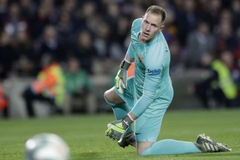Barcelona's goalkeeper Marc-Andre ter Stegen looks at the ball during a Spanish La Liga soccer match between Barcelona and Real Madrid at Camp Nou stadium in Barcelona, Spain, Wednesday, Dec. 18, 2019. Thousands of Catalan separatists are planning to protest around and inside Barcelona's Camp Nou Stadium during Wednesday's "Clasico". (AP Photo/Bernat Armangue)