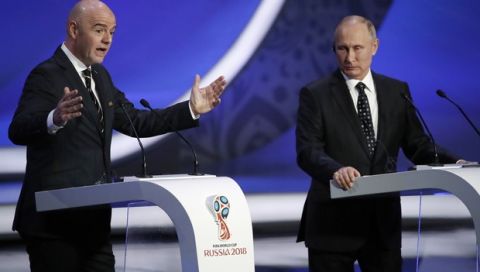 FIFA president Gianni Infantino, left, gestures as he speaks watched by Russian President Vladimir Putin during the 2018 soccer World Cup draw in the Kremlin in Moscow, Friday Dec. 1, 2017. (AP Photo/Pavel Golovkin)