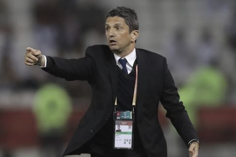 Al Hilal's head coach Razvan Lucescu gives instructions from the side line during the Club World Cup soccer match between Al Hilal FC and ES Tunis at Jassim Bin Hamad Stadium in Doha, Qatar, Saturday, Dec. 14, 2019. (AP Photo/Hassan Ammar)