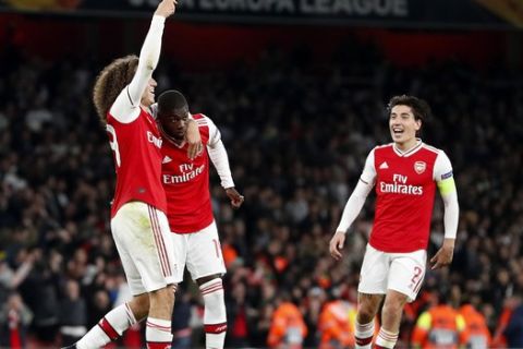 Arsenal's Nicolas Pepe, centre, celebrates with teammates after scoring his side's third goal during the Europa League group F soccer match between Arsenal and Vitoria SC in London, Thursday, Oct. 24, 2019. (AP Photo/Alastair Grant)