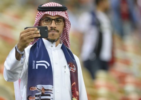 A Saudi man takes a selfie ahead of the Italian Super Cup final soccer match between AC Milan and Juventus at King Abdullah stadium in Jiddah, Saudi Arabia, Wednesday, Jan. 16, 2019. (AP Photo)