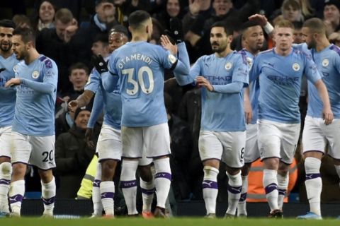 Manchester City's Ilkay Gundogan, center right, celebrates after scoring his side's second goal from the penalty spot during the English Premier League soccer match between Manchester City and Leicester City at Etihad stadium in Manchester, England, Saturday, Dec. 21, 2019. (AP Photo/Rui Vieira)