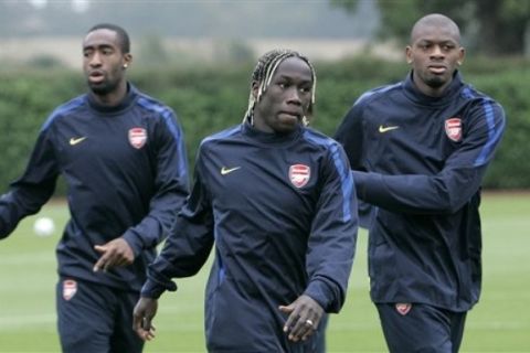 Arsenal's Bacary Sagna, center, Johan Djourou, left, and Abu Diaby take part in a training session at their training facilities in London Colney, England, Monday, Sept. 27, 2010. Arsenal play FK Partizan in a Champions League Group H soccer match in Belgrade on Tuesday. (AP Photo/Akira Suemori)
