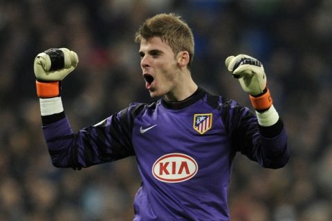 Atletico Madrid's goalkeeper David de Gea celebrates after scoring during the Copa del Rey (King's Cup) football match Real Madrid CF vs Club Atletico de Madrid on January 13, 2011 at the Santiago Bernabeu stadium in Madrid.    AFP PHOTO/ JAVIER SORIANO (Photo credit should read JAVIER SORIANO/AFP/Getty Images)