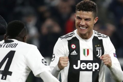 Juventus' Cristiano Ronaldo celebrates with teammate Blaise Matuidi , left, at the end of the Champions League round of 16, 2nd leg, soccer match between Juventus and Atletico Madrid at the Allianz stadium in Turin, Italy, Tuesday, March 12, 2019. Ronaldo scored the three goals in Juventus 3-0 win.(AP Photo/Antonio Calanni)
