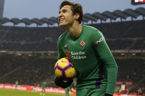 Fiorentina's Federico Chiesa smiles as he holds the ball during a Serie A soccer match between AC Milan and Fiorentina, at the San Siro stadium in Milan, Italy, Saturday, Dec. 22, 2018. (AP Photo/Luca Bruno)