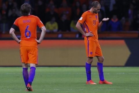 Netherland's Bas Dost, right, and his teammate Georginio Wijnaldum stand at the end of the World Cup Group A soccer qualifying match between the Netherlands and Sweden at the ArenA stadium in Amsterdam, Netherlands, Tuesday, Oct. 10, 2017. (AP Photo/Peter Dejong)