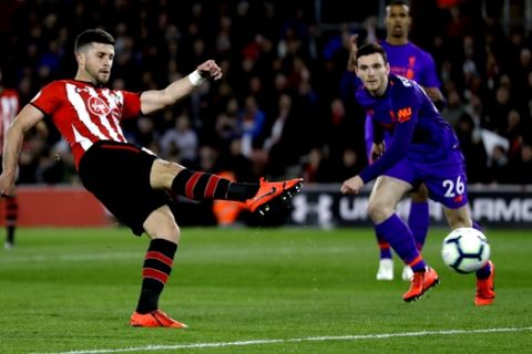 Southampton's Shane Long, left, scores his side's opening goal during the English Premier League soccer match between Southampton and Liverpool at St Mary's stadium in Southampton, England Friday, April 5, 2019. (AP Photo/Kirsty Wigglesworth)
