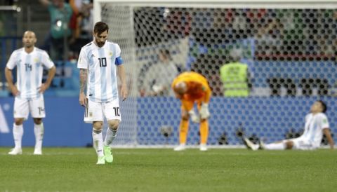 Argentina's Lionel Messi, foreground, looks down as he walks on the pitch after the group D match between Argentina and Croatia at the 2018 soccer World Cup in Nizhny Novgorod Stadium in Nizhny Novgorod, Russia, Thursday, June 21, 2018. Croatia won 3-0. (AP Photo/Petr David Josek)