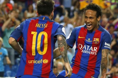 Barcelona's Lionel Messi celebrates with Barcelona's Neymar after scoring his team's first goal during the Copa del Rey final soccer match between Barcelona and Alaves at the Vicente Calderon stadium in Madrid, Spain, Saturday May 27, 2017. (AP Photo/Daniel Ochoa de Olza)