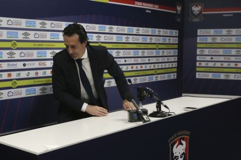 PSG head coach Unai Emery stands up at the end of his last press conference of his League One soccer match between Caen and Paris Saint-Germain at the Michel d'Ornano stadium in Caen, western France, Saturday, May 19, 2018. This is his last match with the PSG team. German coach Thomas Tuchel will replace him for the next season. (AP Photo/David Vincent)