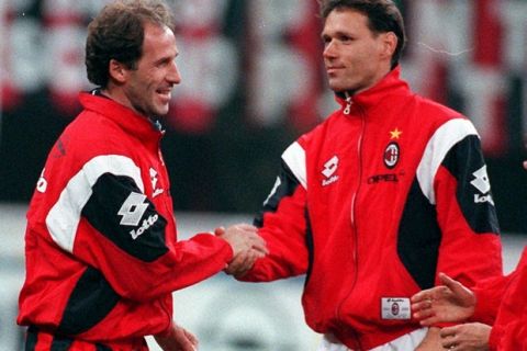 Italian soccer legend Franco Baresi, left, shaking hands with Dutch former striker Marco Van Basten at the Milan San Siro stadium before the start of an benefit match marking his retirement, Tuesday, October 28, 1997.  Baresi announced his retirement last June after a 20-year-long career which redifined the sweeper position. (AP Photo/Carlo Fumagalli)
