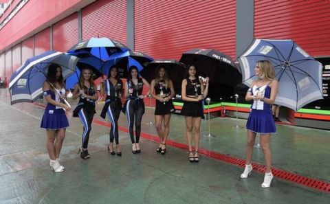 Grid girls pose at the pits before the warm-up of the MotoGP of the Argentina Grand Prix at Termas de Rio Hondo circuit, in Santiago del Estero, Argentina, on April 3, 2016. AFP PHOTO / JUAN MABROMATA / AFP / JUAN MABROMATA        (Photo credit should read JUAN MABROMATA/AFP/Getty Images)
