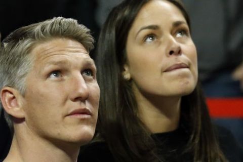 The Chicago Fire's new player Bastian Schweinsteiger, of Germany, left, and his wife Ana Ivanovic look up the score board as they watch an NBA basketball game between the Chicago Bulls and the Cleveland Cavaliers Thursday, March 30, 2017, in Chicago. The Bulls won 99-93. (AP Photo/Nam Y. Huh)