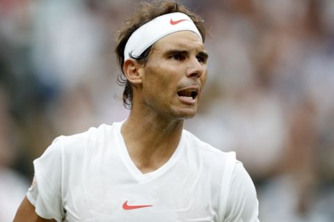 Rafael Nadal of Spain wins a point from Novak Djokovic of Serbia during the men's singles semifinal match at the Wimbledon Tennis Championships, in London, Saturday July 14, 2018. (Nic Bothma, Pool via AP)