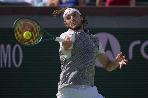 Stefanos Tsitsipas, of Greece, returns a shot against Frances Tiafoe, of the United States, at the BNP Paribas Open tennis tournament in Indian Wells, Calif., Sunday, March 10, 2024. (AP Photo/Ryan Sun)