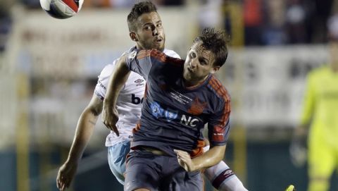 West Ham United's Diego Poyet, back, and Carolina Railhawks' Billy Schuler (17) chase the ball in the second half of an international friendly soccer match in Cary, N.C., Tuesday, July 12, 2016. The match ended in a 2-2 tie. (AP Photo/Gerry Broome)