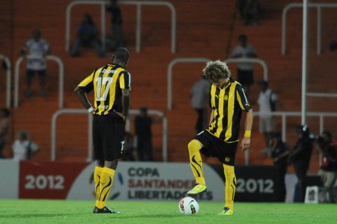 Uruguay's Marcos Zalayeta (L) and Maximiliano Perez stand on the field during the Copa Libertadores group 8 football match between Argentina's Godoy Cruz and Uruguay's Penarol at Malvinas Argentinas stadium in Mendoza, Argentina, on February 16, 2012. AFP PHOTO / Andres Larrovere (Photo credit should read ANDRES LARROVERE/AFP/Getty Images)