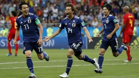 Japan's Takashi Inui, center, celebrates after scoring his side's second goal during the round of 16 match between Belgium and Japan at the 2018 soccer World Cup in the Rostov Arena, in Rostov-on-Don, Russia, Monday, July 2, 2018. (AP Photo/Petr David Josek)