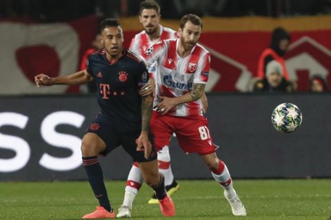 Bayern's Corentin Tolisso, left, challenges for the ball with Red Star's Jose Canas during the Champions League group B soccer match between Red Star and FC Bayern Munich at the Rajko Mitic Stadium, in Belgrade, Serbia, Tuesday, Nov. 26. (AP Photo/Darko Vojinovic)