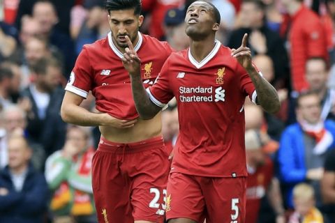 Liverpool's Georginio Wijnaldum, right, celebrates scoring against Middlesbrough with teammate Emre Can during the English Premier League soccer match against Middlesbrough at Anfield, Liverpool, England, Sunday May 21, 2017. (Peter Byrne/PA via AP)