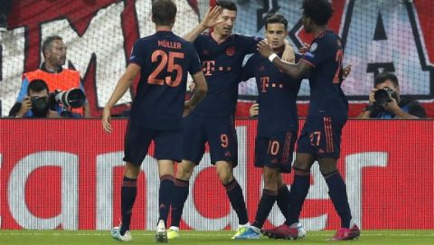 Bayern's Robert Lewandowski, second left, celebrates with team mates Bayern's Philippe Coutinho, second right, Bayern's Thomas Mueller, left, and Bayern's David Alaba after scoring his side's second goal during the Champions League group B soccer match between Olympiakos and Bayern Munich at the Georgios Karaiskakis stadium, in Piraeus port, near Athens, Tuesday, Oct. 22, 2019. (AP Photo/Thanassis Stavrakis)