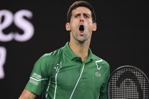 Serbia's Novak Djokovic reacts during his match against Austria's Dominic Thiem in the men's singles final at the Australian Open tennis championship in Melbourne, Australia, Sunday, Feb. 2, 2020. (AP Photo/Andy Brownbill)