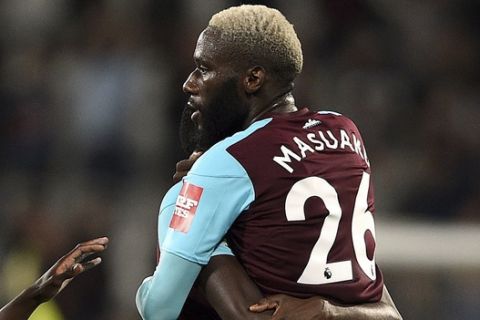 West Ham United's Arthur Masuaku, right, celebrates scoring his side's third goal of the game during their English League Cup, third round match, West Ham against Bolton at the London Stadium in London, Tuesday, Sept. 19, 2017. (Daniel Hambury/PA via AP)