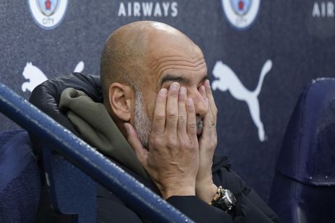 Manchester City's head coach Pep Guardiola sits on the bench before the start of the English Premier League soccer match between Manchester City and Fulham at Etihad stadium in Manchester, England, Saturday, Nov. 5, 2022. (AP Photo/Dave Thompson)