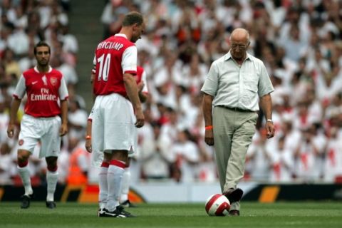 Arsenal's Dennis Bergkamp, left, kicks off the friendly soccer match against Ajax with his father Wim, right, at the Emirates stadium, London, Saturday July 22, 2006. Saturday's match is the first game to be played in Arsenal's new home stadium.(AP Photo/Tom Hevezi)