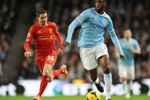 Football - Manchester City v Liverpool - Barclays Premier League - Etihad Stadium - 26/12/13
Manchester City's Yaya Toure and Liverpool's Joe Allen (L) in action
Mandatory Credit: Action Images / Paul Currie
Livepic
EDITORIAL USE ONLY. No use with unauthorized audio, video, data, fixture lists, club/league logos or live services. Online in-match use limited to 45 images, no video emulation. No use in betting, games or single club/league/player publications.  Please contact your account representative for further details.