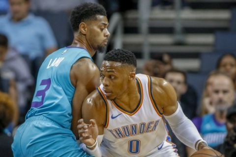 Oklahoma City Thunder guard Russell Westbrook, right, drives against Charlotte Hornets guard Jeremy Lamb during the first half of an NBA basketball game in Charlotte, N.C., Thursday, Nov. 1, 2018. (AP Photo/Nell Redmond)
