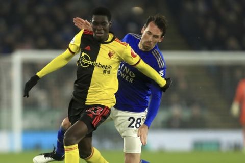 Watford's Ismaila Sarr left wins the ball against Leicester's Christian Fuchs during the English Premier League soccer match between Leicester City and Watford at the King Power Stadium, in Leicester, England, Wednesday, Dec. 4, 2019. (AP Photo/Leila Coker)