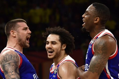 Anadolu's Adrien Moerman, left, Shane Larkin, center, and James Anderson celebrate during the Euroleague Final Four semifinal basketball match between Anadolu Efes Istanbul and Fenerbahce Beko Istanbul at the Fernando Buesa Arena in Vitoria, Spain, Friday, May 17, 2019. (AP Photo/Alvaro Barrientos)