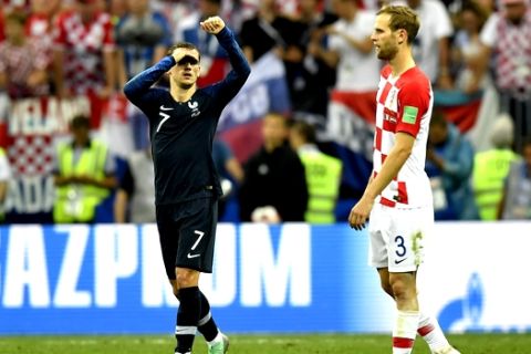 France's Antoine Griezmann celebrates beside Croatia's Ivan Strinic, right, after scoring his side's second goal during the final match between France and Croatia at the 2018 soccer World Cup in the Luzhniki Stadium in Moscow, Russia, Sunday, July 15, 2018. (AP Photo/Martin Meissner)