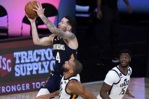 New Orleans Pelicans' JJ Redick (4) shoots over Utah Jazz's Rudy Gobert and Emmanuel Mudiay, right, during the second half of an NBA basketball game Thursday, July 30, 2020, in Lake Buena Vista, Fla. (AP Photo/Ashley Landis, Pool)