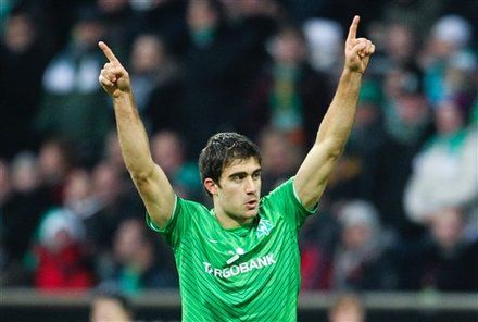 Bremen's  Sokratis Papastathopoulos  celebrates a goal during the German Bundesliga soccer match between SV Werder Bremen and VfL Wolfsburg in Bremen, northern Germany, Saturday, Dec. 10, 2011. (AP Photo/dapd Joerg Sarbach) NO MOBILE USE UNTIL 2 HOURS AFTER THE MATCH, WEBSITE USERS ARE OBLIGED TO COMPLY WITH DFL-RESTRICTIONS, SEE INSTRUCTIONS FOR DETAILS 