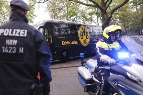 Police guard at the entrance of the Dortmund stadium prior to the German Bundesliga soccer match between Borussia Dortmund and Eintracht Frankfurt, in Dortmund, Saturday, April 15, 2017. Defender Marc Bartra and a police officer were wounded when three explosions hit the team bus as it was leaving for the stadium ahead of the first leg of the Champions League quarterfinal against Monaco Tuesday, April 11, 2017. . (Ina Fassbender/dpa via AP)