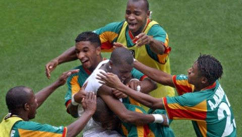 Senegal's Henri Camara is mobed by teammates afterscoring the wiining goal against Sweden in extra time during their 2002 World Cup second-round playoff match Sunday, June 16, in Oita, Japan. Senegal won 2-1. (AP Photo/Walter Astrada)
