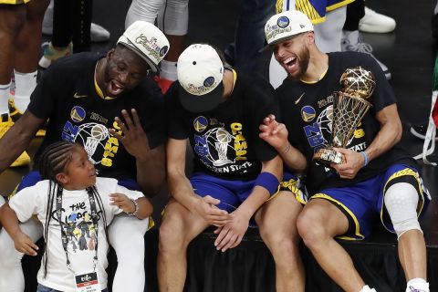 Golden State Warriors guard Stephen Curry, right, forward Draymond Green, left, and Golden State Warriors guard Klay Thompson celebrate after defeating the Boston Celtics in Game 6 to win basketball's NBA Finals championship, Thursday, June 16, 2022, in Boston. (AP Photo/Michael Dwyer)