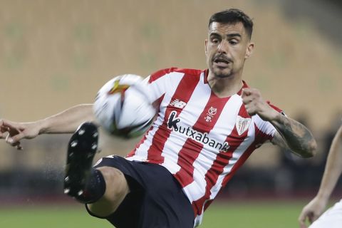 Athletic Bilbao's Dani Garcia, left, clears the ball before Real Sociedad's David Silva, right, during the final of the 2020 Copa del Rey, or King's Cup, soccer match between Athletic Bilbao and Real Sociedad at Estadio de La Cartuja in Sevilla, Spain, Saturday April 3, 2021. The game is the rescheduled final of the 2019-2020 competition which was originally postponed due to the coronavirus pandemic. (AP Photo/Angel Fernandez)